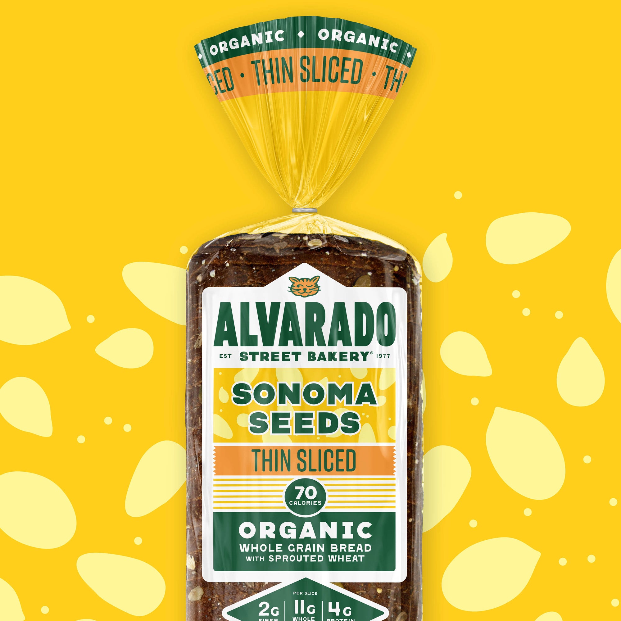 Packaged bread with Alvarado Street Bakery branding on a yellow background with light yellow seed shapes.
