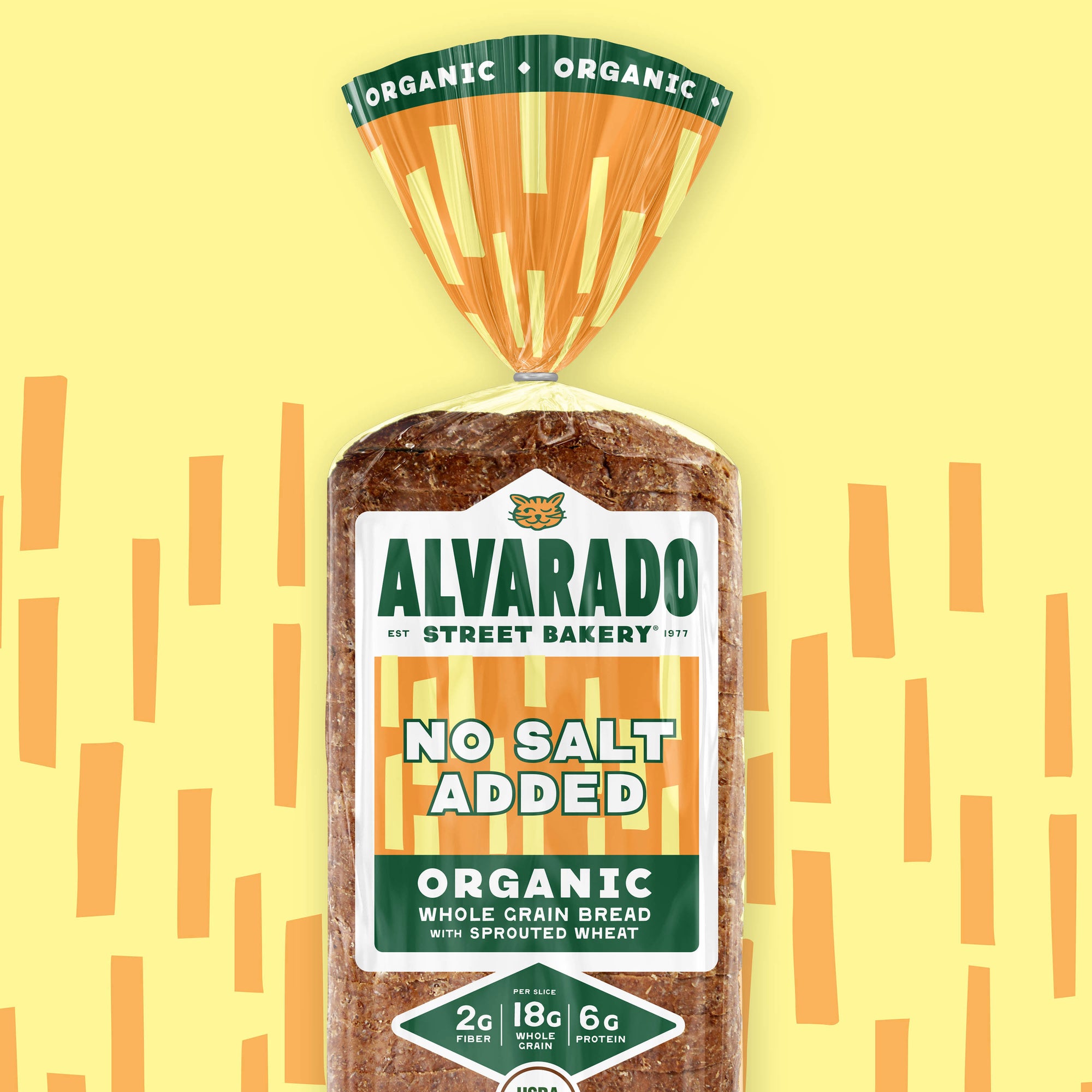 Alvarado Street Bakery no salt added organic whole grain bread package on a yellow background with orange lines.