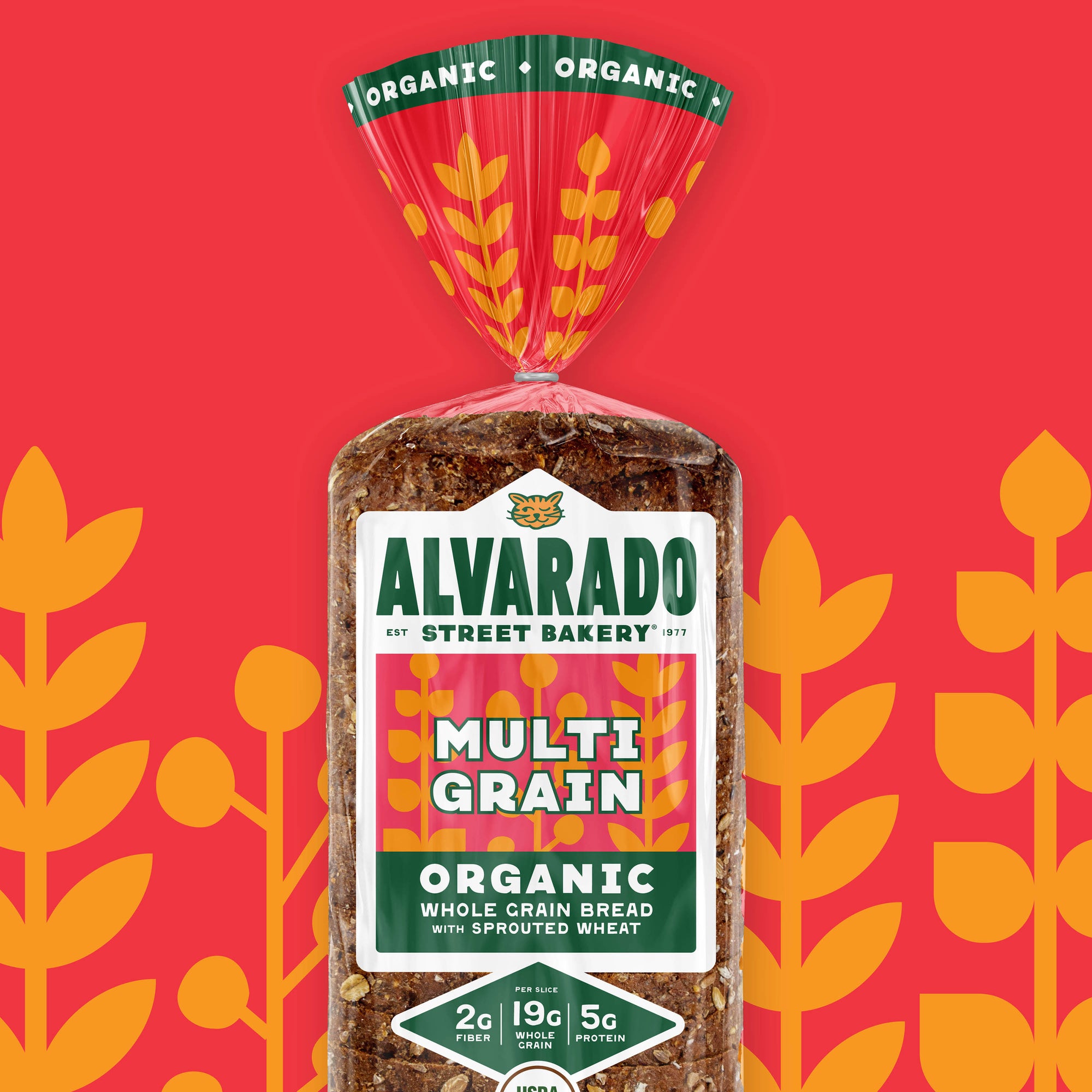 Alvarado Street Bakery Multi Grain bread package on a red background with orange leaf patterns