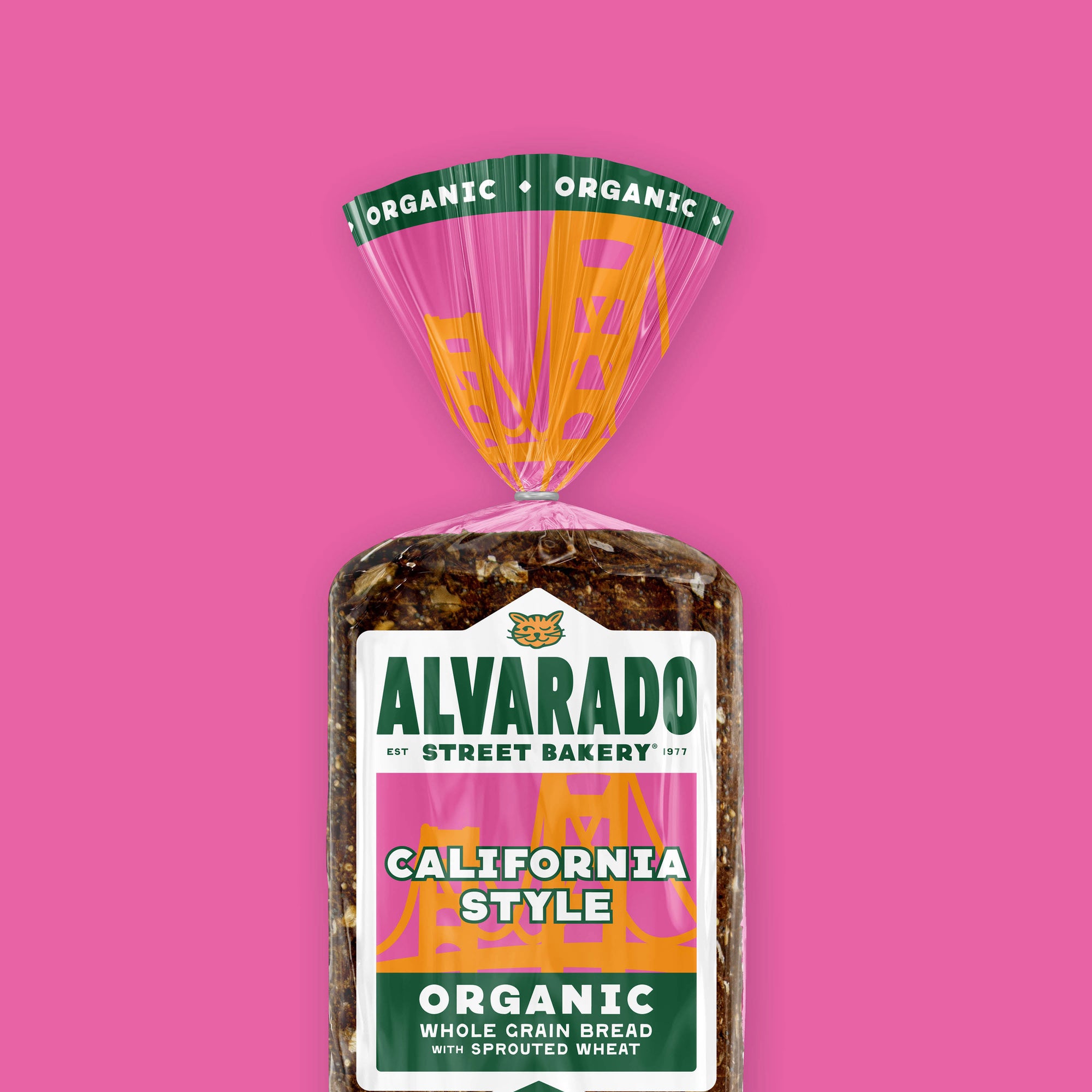 Packaged California Style bread with Alvarado Street Bakery label on a pink background