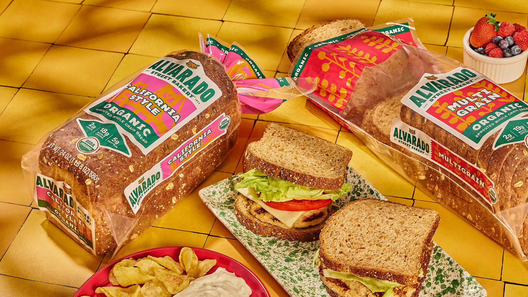 Alvarez bread packages with sandwiches and snacks on a yellow tile surface